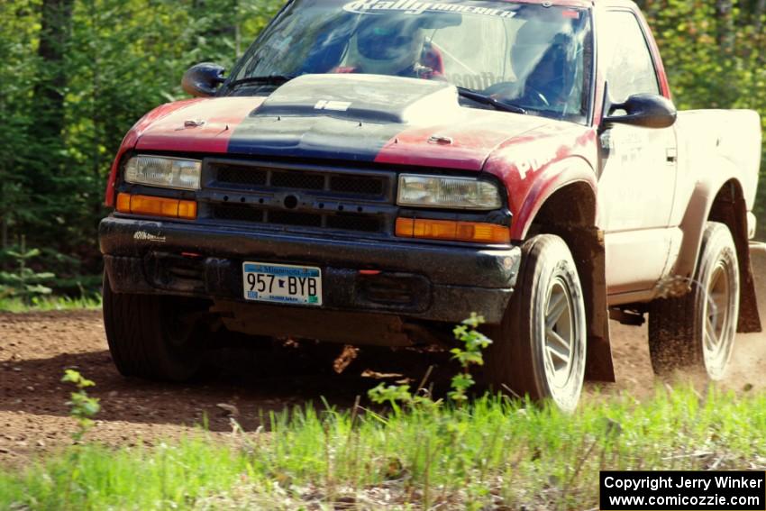 The Jim Cox / Mark Holden Chevrolet S-10 drifts through a sweeper on stage three.