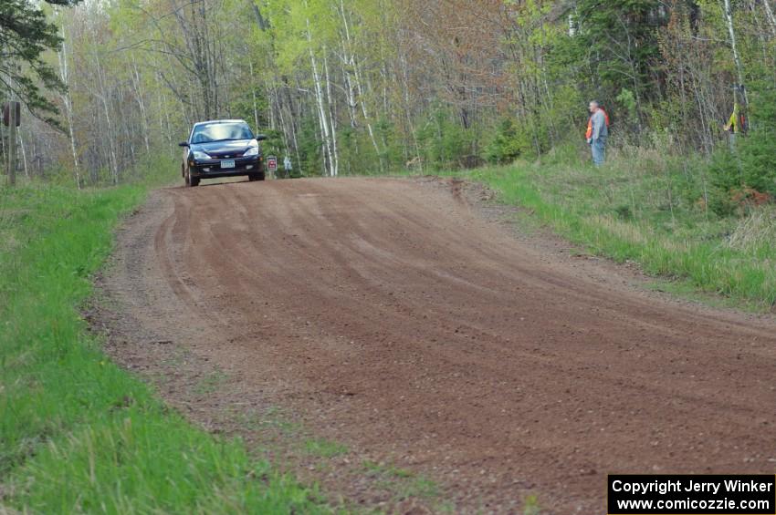 Pawel Dubina / Karol Dubina come over a crest on stage three in their Ford Focus.