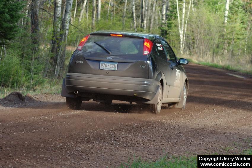 Pawel Dubina / Karol Dubina head downhill into a sweeper in their Ford Focus.