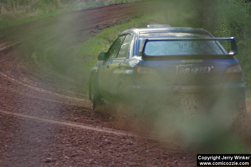 Janusz Topor / Michal Kaminski drift their Subaru WRX STi through a sweeper on stage four.