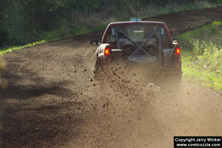 The Jim Cox / Mark Holden Chevrolet S-10 sprays gravel through an uphill sweeper on stage four.