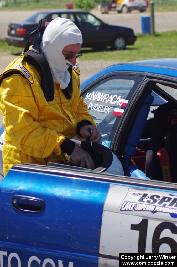 Bartek Stypa readies himself to navigate for Kazimierz Pudelek in his Subaru Impreza