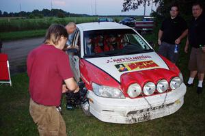 Jan Zedril / Jody Zedril, in their Mitsubishi Lancer ES, are filmed by a Canadian TV crew.