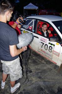 Jan Zedril / Jody Zedril, in their Mitsubishi Lancer ES, are interviewed by a Canadian film crew.