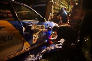 Work is performed on the Janusz Topor / Michal Kaminski Subaru WRX STi at Friday's service.