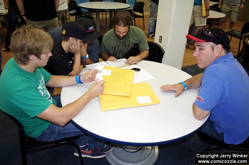 Dillon Van Way, ???, ???, Jake Blattner and Graham Evans discuss notes.