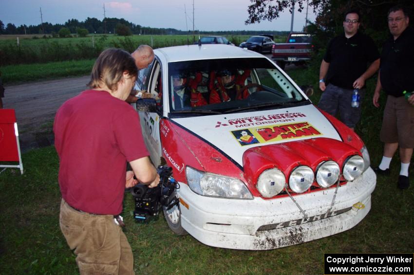 Jan Zedril / Jody Zedril, in their Mitsubishi Lancer ES, are filmed by a Canadian TV crew.