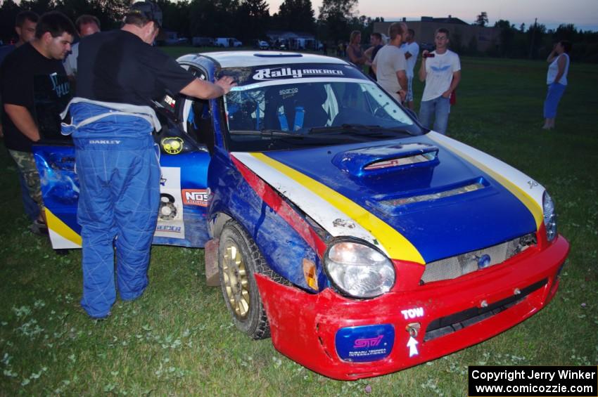 John Topor surveys damage to his Subaru WRX STi that rolled on SS1.