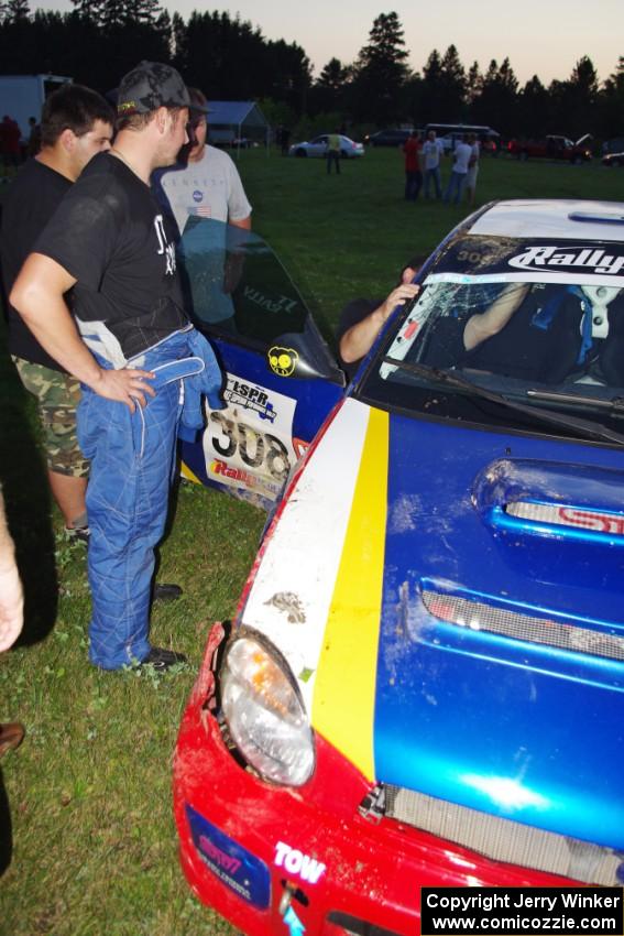 John Topor surveys damage to his Subaru WRX STi that rolled on SS1.