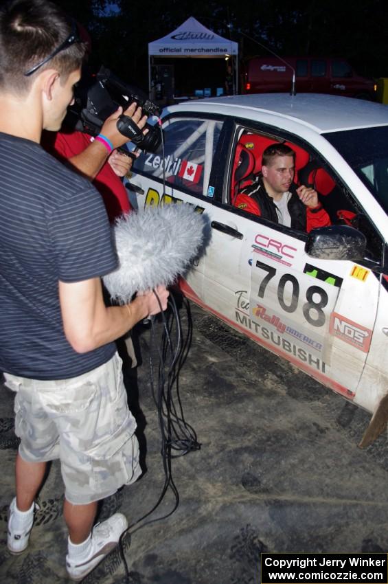 Jan Zedril / Jody Zedril, in their Mitsubishi Lancer ES, are interviewed by a Canadian film crew.