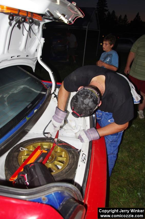 Work is performed on the Janusz Topor / Michal Kaminski Subaru WRX STi at Friday's service.