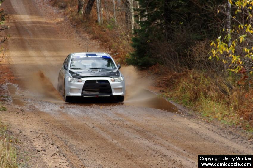 Vio Dobasu / Nathalie Richard in their Mitsubishi Lancer Evo X near the finish of SS10 (Menge Creek 1)