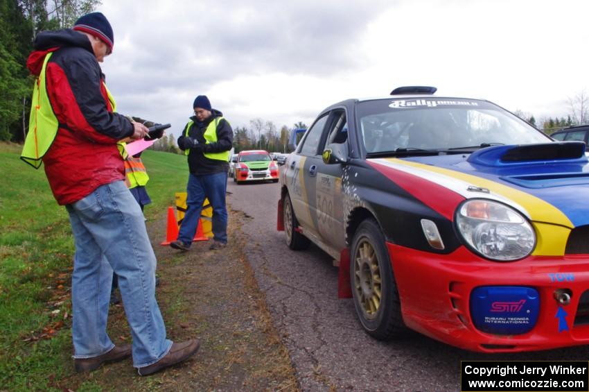 Janusz Topor / Michal Kaminski in their Subaru WRX STi about to head back out after L'Anse service