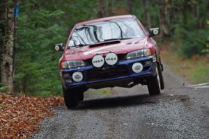 Brianne Corn / Jeremy Rowland in their Subaru Impreza catch air on SS13 (Herman 1)