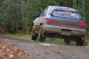 Piotr Fetela / Ray Vambuts in their Subaru Impreza STi catch air on SS13 (Herman 1)