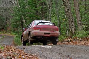 Chris Gordon / Jennifer Majszak in their Subaru Impreza catch air on SS13 (Herman 1)