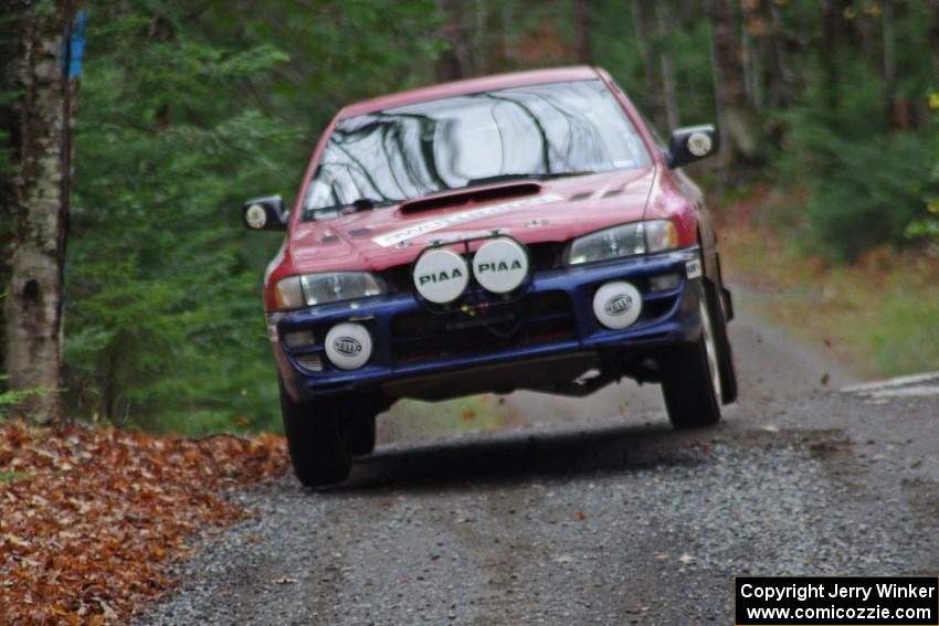 Brianne Corn / Jeremy Rowland in their Subaru Impreza catch air on SS13 (Herman 1)