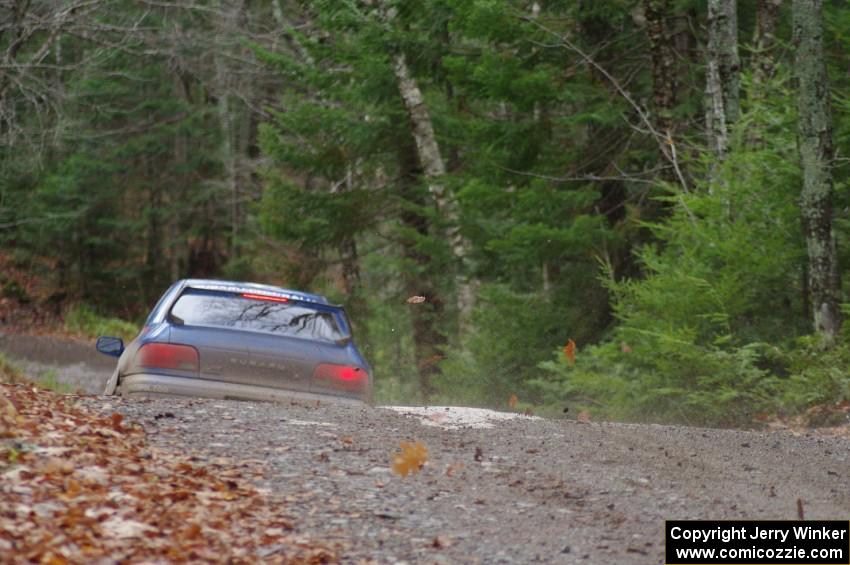 Piotr Fetela / Ray Vambuts in their Subaru Impreza STi catch air on SS13 (Herman 1)