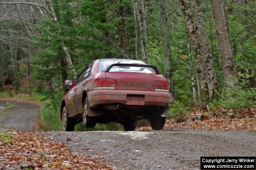 Chris Gordon / Jennifer Majszak in their Subaru Impreza catch air on SS13 (Herman 1)