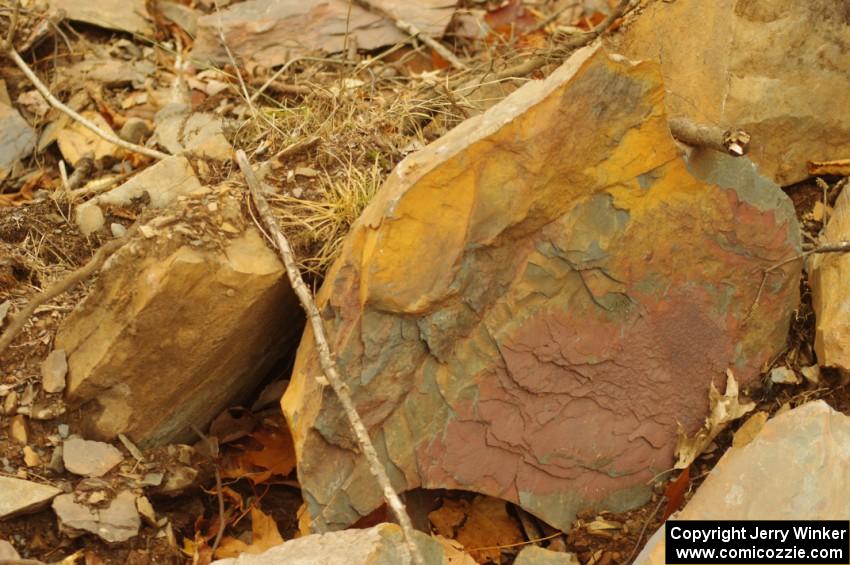 Multi-colored slate at the side of the road on SS16 (Arvon Tower 2)