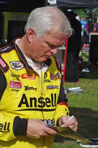 Frank Kimmel signs an autograph in the paddock.