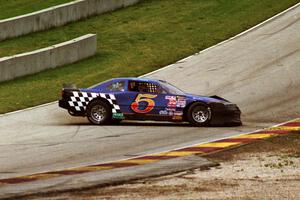 Steve Kracht's Dodge Avenger spins after getting back onto the track.