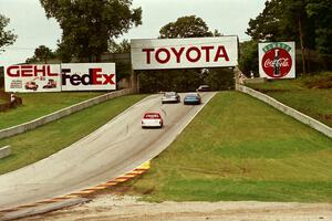 Mid-American Stock Cars and Super Trucks head uphill toward corner 6.