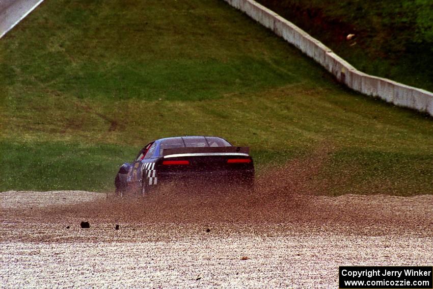 Steve Kracht's Dodge Avenger takes a wild ride off into the gravel at turn 5.