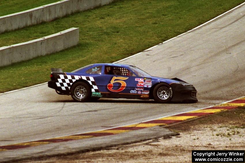 Steve Kracht's Dodge Avenger spins after getting back onto the track.