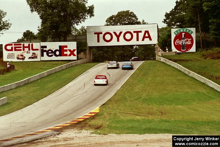 Mid-American Stock Cars and Super Trucks head uphill toward corner 6.