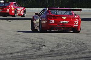 Pete Halsmer's Chevy Camaro follows Cameron Lawrence's Chevy Camaro out of turn 12 into 13.