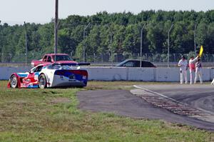 Jed Copham's Chevy Corvette spins onto the dirt at turn 12