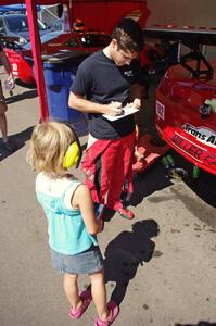 Cameron Lawrence signs an autograph for a young fan.