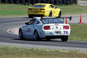 Chuck Cassaro's Ford Mustang chases down Tom Sheehan's Chevy Camaro