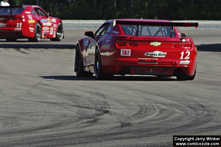 Pete Halsmer's Chevy Camaro follows Cameron Lawrence's Chevy Camaro out of turn 12 into 13.