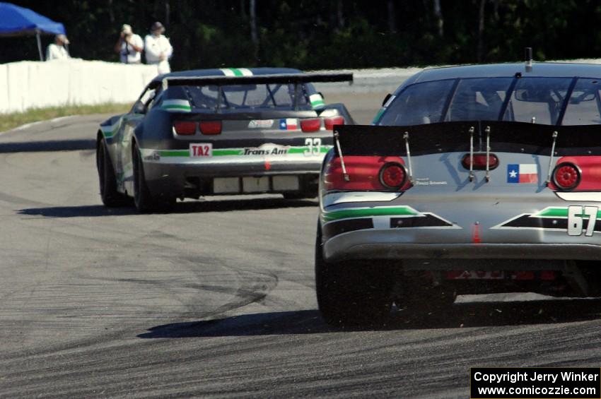 Scott Ferguson's Pontiac GTO.R follows Gregg Rodgers's Chevy Camaro out of turn 12