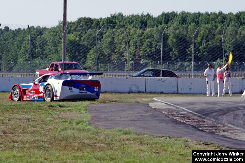 Jed Copham's Chevy Corvette spins onto the dirt at turn 12