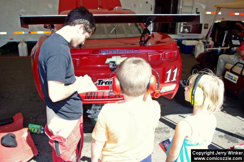 Cameron Lawrence signs an autograph for a young fan.