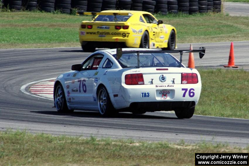 Chuck Cassaro's Ford Mustang chases down Tom Sheehan's Chevy Camaro