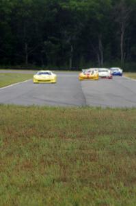 The field comes into turn 4 on the first lap.