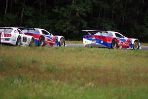 Simon Gregg's and Jed Copham's Chevy Corvettes hold off Cliff Ebben's Ford Mustang