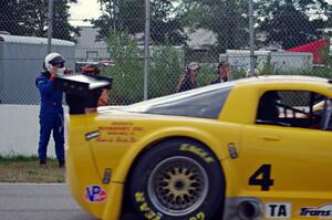 Dale Madsen parks his Ford Mustang after an accident on the re-start. Tony Ave's Chevy Corvette passes by.