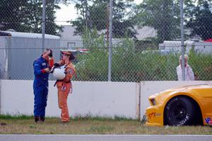 Dale Madsen parks his Ford Mustang after an accident on the re-start