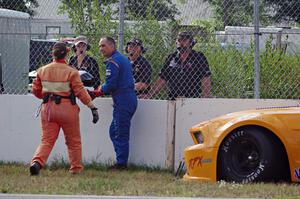 Dale Madsen parks his Ford Mustang after an accident on the re-start
