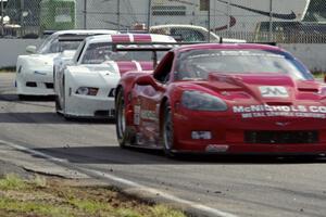 Amy Ruman's Chevy Corvette and Cliff Ebben's Ford Mustang ahead of Simon Gregg's Chevy Corvette