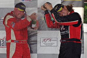 Race winner Doug Peterson sprays Amy Ruman who took the final podium spot