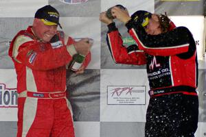 Race winner Doug Peterson sprays Amy Ruman who took the final podium spot