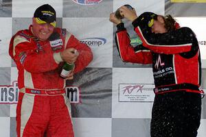 Race winner Doug Peterson sprays Amy Ruman who took the final podium spot