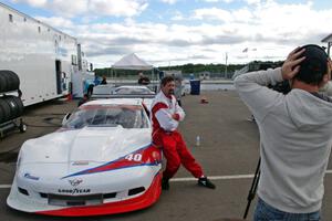 Jed Copham does a post-race interview in front of his Chevy Corvette