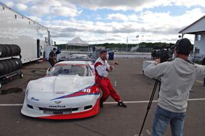 Jed Copham does a post-race interview in front of his Chevy Corvette